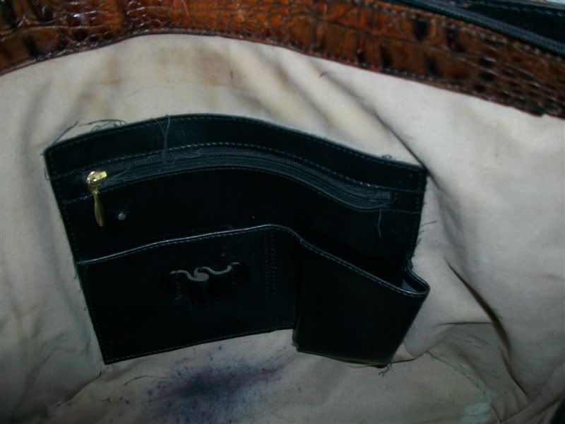 Inside lined in light suede & shows soil,stains & ink stains inside 